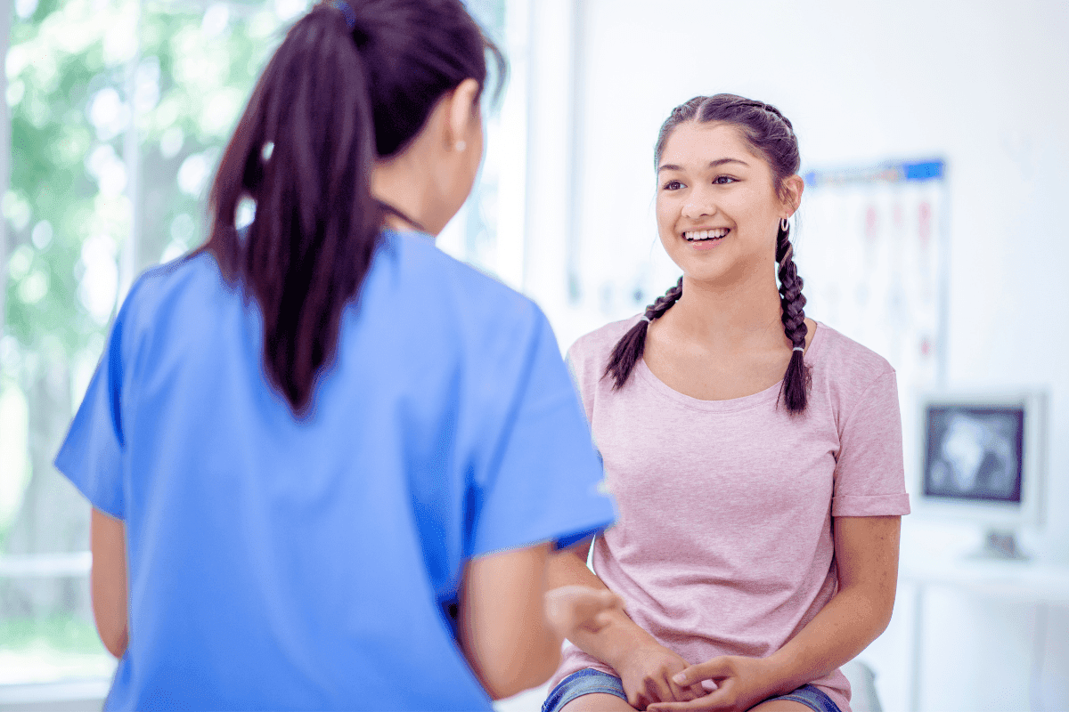 Provider smiling with patient in exam room