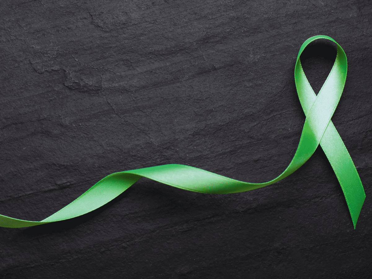 green ribbon worn during Mental Health Awareness month