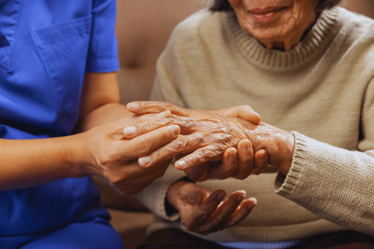 woman with rheumatoid arthritis has hand examined
