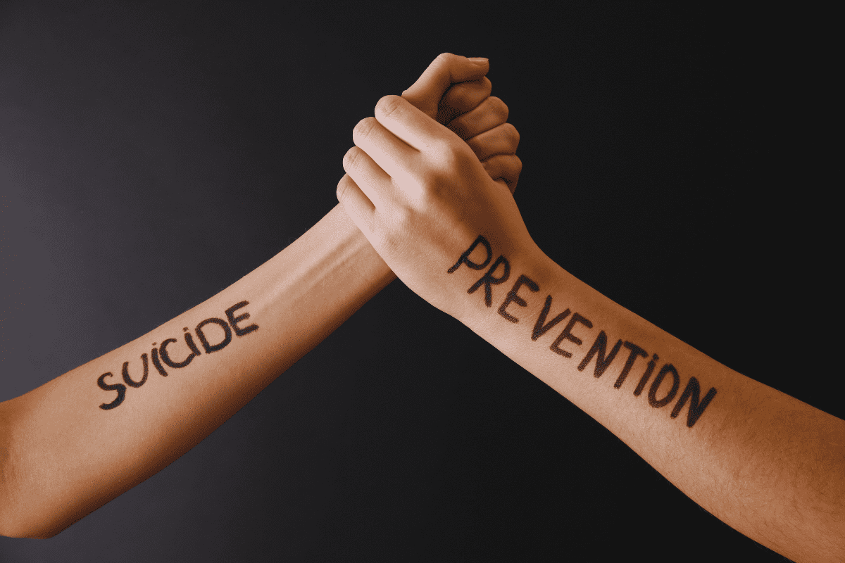 arms clasped in solidarity for suicide prevention month