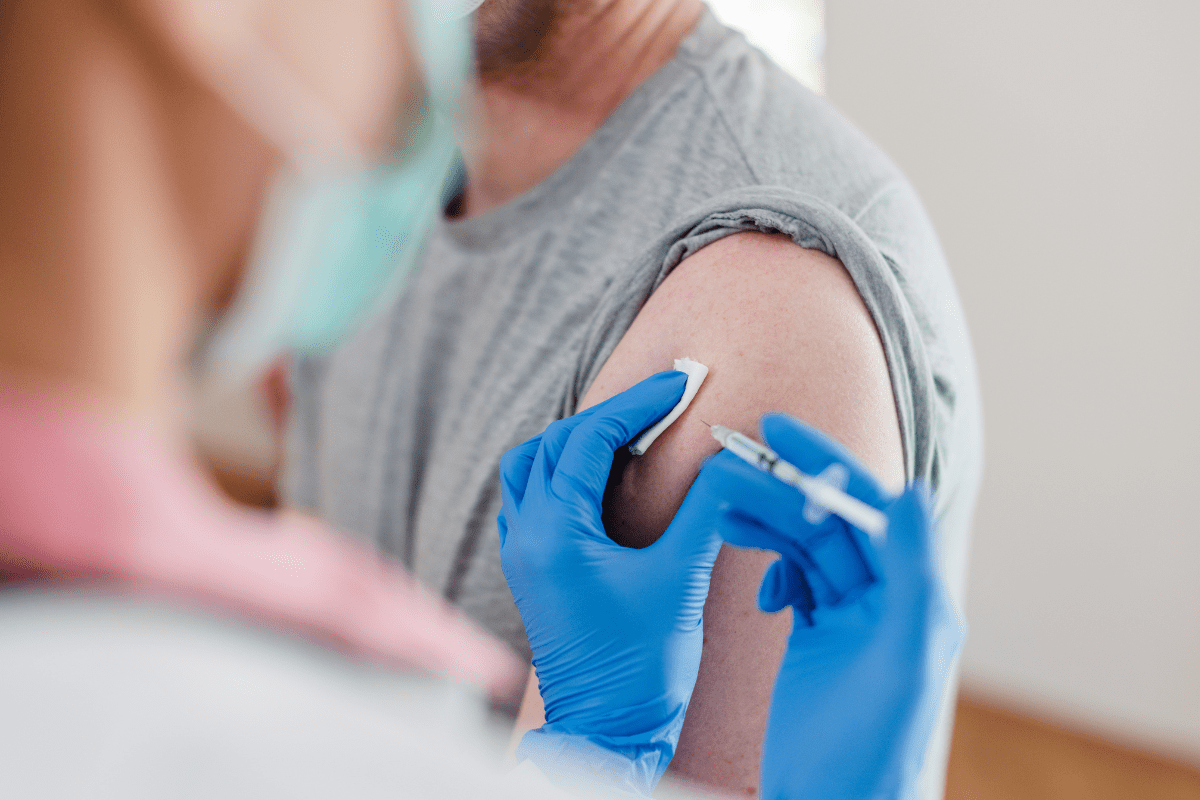 man receiving vaccine booster in deltoid muscle