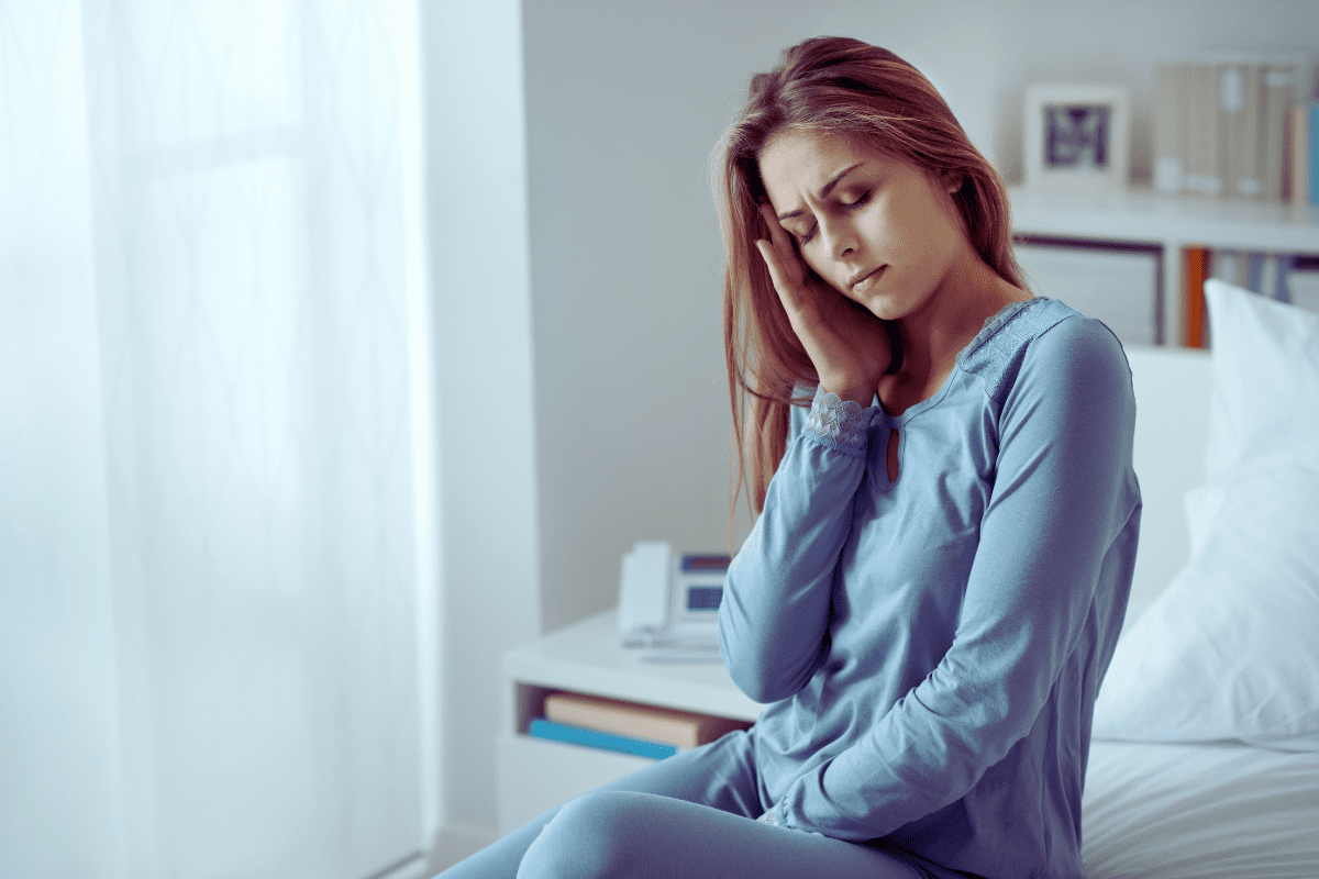 woman rubbing temple to indicate onset of a migraine